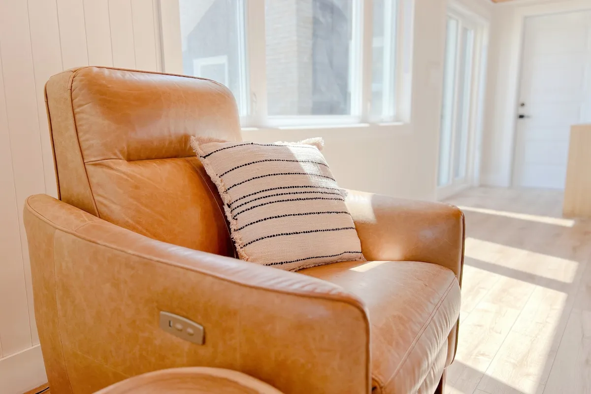 Leather armchair by the window at Tiki cottage