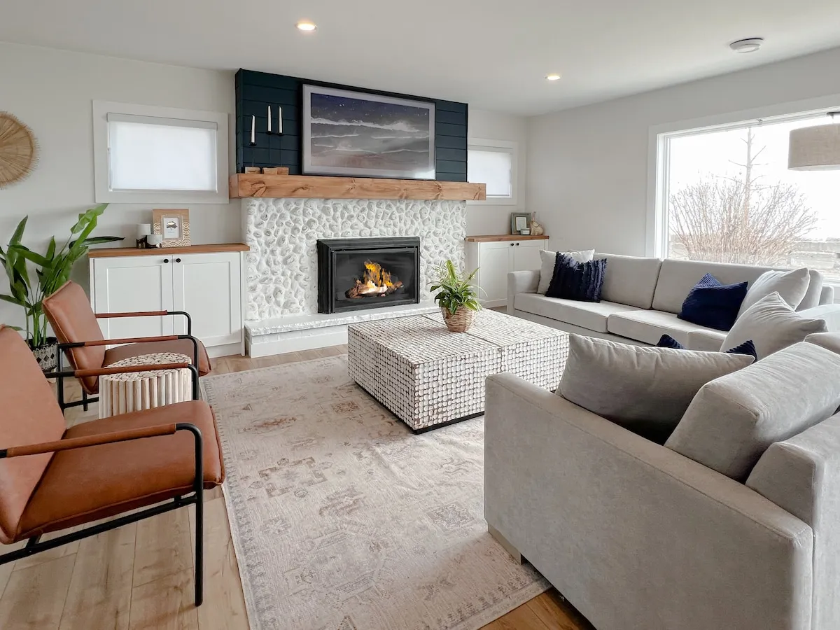 Living room with stone fireplace and sofas at Cedar cottage