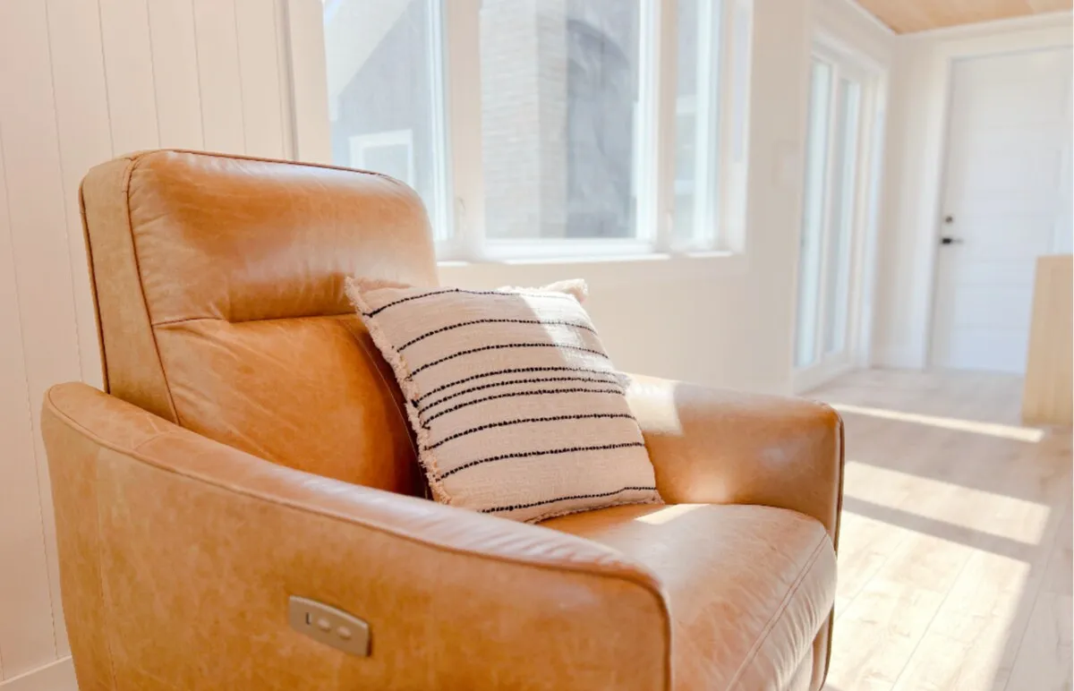 Leather armchair by the window in the Tiki side of the Cedar + Tiki Suite