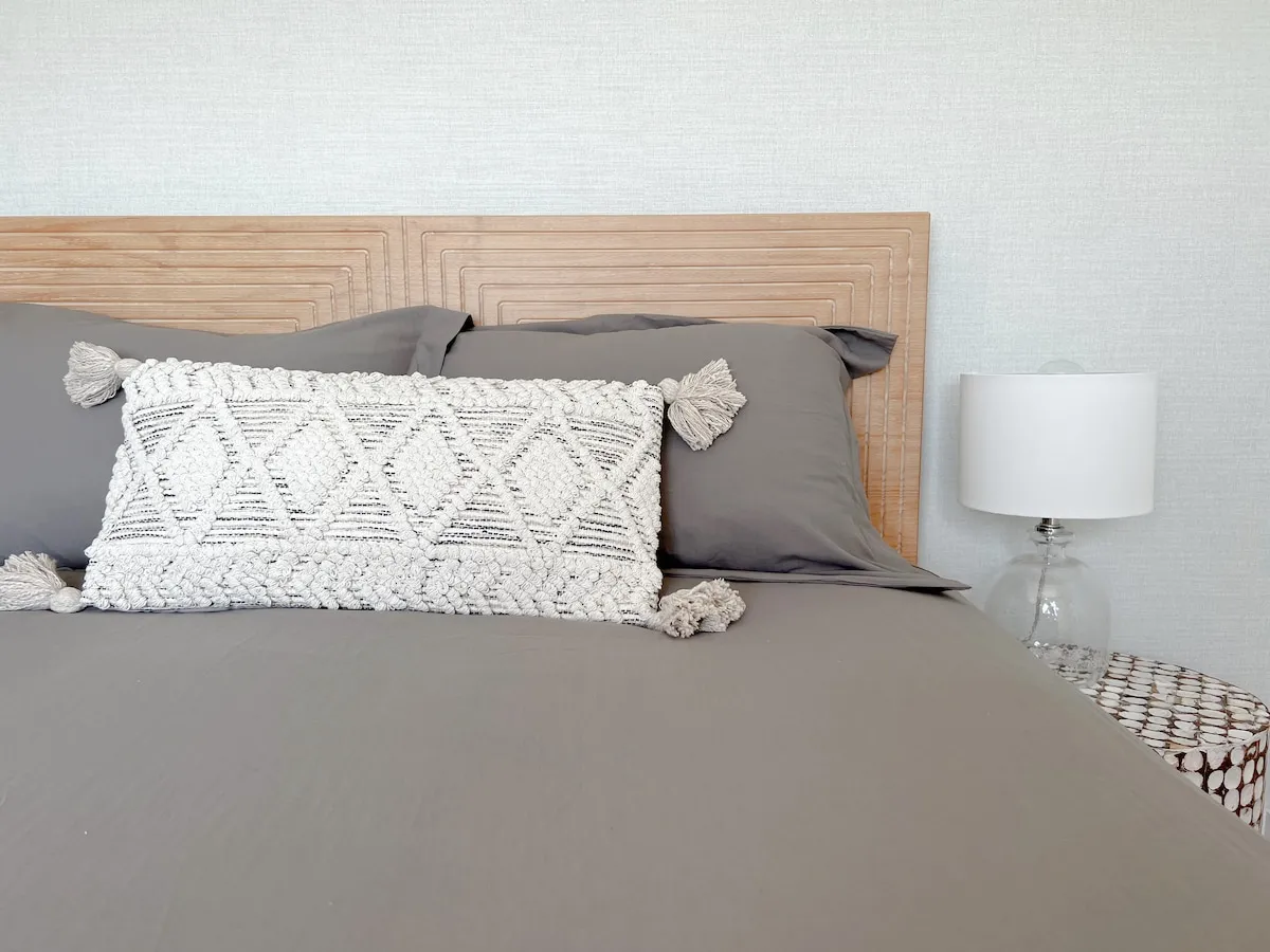 Bed with decorative pillows in a Cedar cottage bedroom