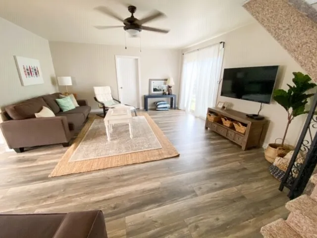 Open living area with rug and lounge chairs at Harold cottage
