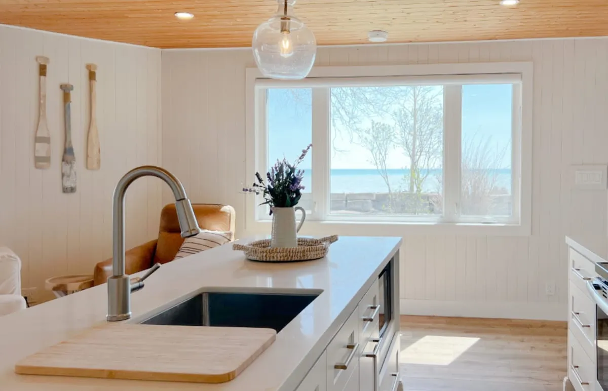 Kitchen sink with a view of Lake Erie in the Tiki side of the Cedar + Tiki Suite