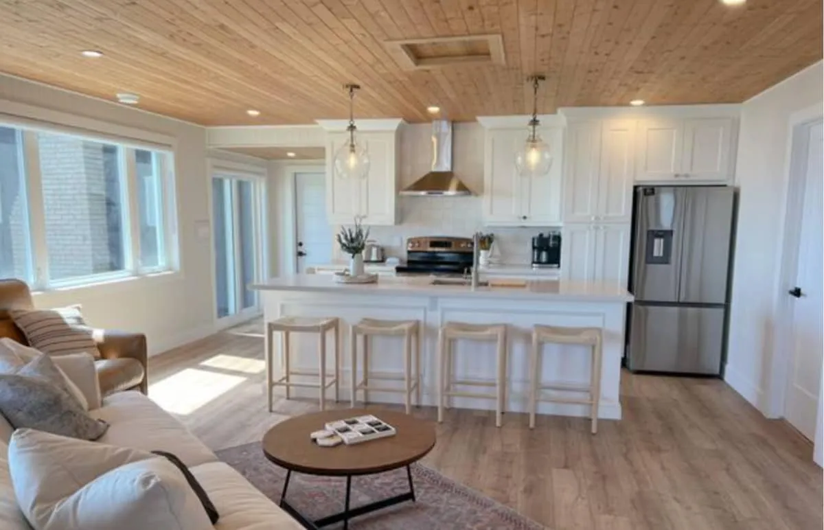 Open-concept kitchen and living room with wood ceiling in the Tiki side of the suite
