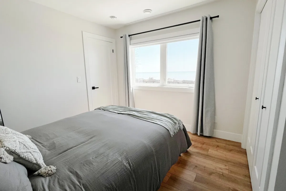 Bright bedroom with window at Cedar cottage