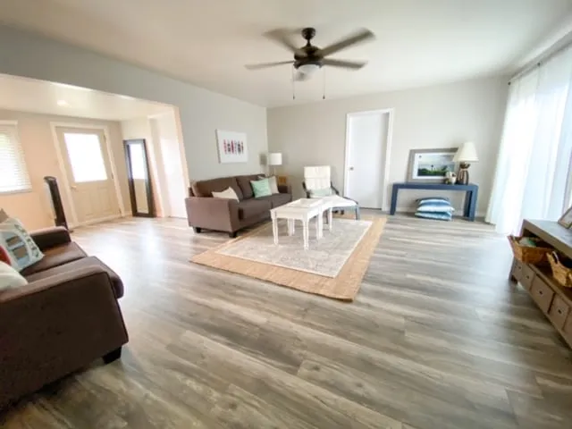 Bright living room with wood-look floors at Harold cottage